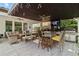 Beautiful outdoor space perfect for entertaining with a dining table, bar, grill, and lounge area at 8515 Morehouse Dr, Orlando, FL 32836