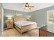 Serene bedroom featuring tile floors, neutral paint, and natural light from the window at 8895 Palisades Beach Ave, Orlando, FL 32829