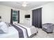 Comfortable bedroom featuring neutral tones, soft carpet, and a dresser with wall-mounted television at 8988 Cabot Cliffs Dr, Champions Gate, FL 33896