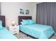 Bedroom with twin beds, light blue bedding, and gray curtains at 8988 Cabot Cliffs Dr, Champions Gate, FL 33896