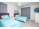 Bedroom with twin beds, light blue bedding and gray curtains at 8988 Cabot Cliffs Dr, Champions Gate, FL 33896