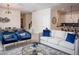 Open-concept living area with stylish furnishings and seamless flow to the dining and kitchen areas at 8988 Cabot Cliffs Dr, Champions Gate, FL 33896