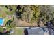 An aerial view of the lot featuring mature trees, a privacy fence, and an outbuilding at 9350 2Nd Ave, Orlando, FL 32824
