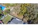 An aerial view of the property, highlighting the lot with fencing and mature trees at 9350 2Nd Ave, Orlando, FL 32824