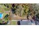Aerial view of a large, tree-filled lot with a clearly marked property line in a quiet residential neighborhood at 9350 2Nd Ave, Orlando, FL 32824