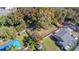An aerial view showcases a sizable lot defined by a red boundary line, nestled in a verdant residential area at 9350 2Nd Ave, Orlando, FL 32824