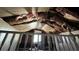 Damaged attic with view to the window and exposed insulation at 9350 2Nd Ave, Orlando, FL 32824