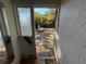 Backyard view through the damaged doorway and window at 9350 2Nd Ave, Orlando, FL 32824