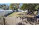 Fenced backyard featuring a grassy lawn, mature trees, and space for parking or other recreational activities at 9350 2Nd Ave, Orlando, FL 32824