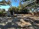 Large, shaded backyard featuring mature trees and a storage shed for outdoor equipment at 9350 2Nd Ave, Orlando, FL 32824
