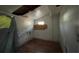 Bedroom featuring wood floors and walls in need of repair at 9350 2Nd Ave, Orlando, FL 32824