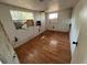 Interior view of a bedroom with hardwood floors and windows with damage at 9350 2Nd Ave, Orlando, FL 32824
