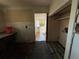 Kitchen with broken floors and torn walls, ideal for a complete renovation to create a personalized space at 9350 2Nd Ave, Orlando, FL 32824