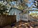 A side view of a single-Gathering home with mature landscaping at 9350 2Nd Ave, Orlando, FL 32824