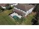 Aerial shot showcases a private pool, covered patio, and meticulously landscaped backyard, perfect for outdoor entertaining at 9526 Lake Hugh Dr, Gotha, FL 34734