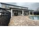 A picturesque backyard featuring a sparkling pool, patio, and a comfortable seating area for relaxation at 9526 Lake Hugh Dr, Gotha, FL 34734