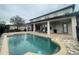 Spacious backyard with a luxurious pool and covered patio area, great for outdoor entertaining at 9526 Lake Hugh Dr, Gotha, FL 34734