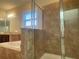 Bathroom featuring a walk-in shower with glass doors and a soaking tub at 9526 Lake Hugh Dr, Gotha, FL 34734