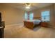 Bedroom featuring carpet, ceiling fan, a window and a standard bed with side tables at 9526 Lake Hugh Dr, Gotha, FL 34734