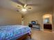 Bedroom featuring carpet, ceiling fan, a bed with side tables, and an entrance to the bathroom at 9526 Lake Hugh Dr, Gotha, FL 34734