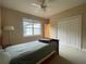 Neutral bedroom featuring carpet, ceiling fan, bed, a window and white closet doors at 9526 Lake Hugh Dr, Gotha, FL 34734