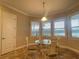 Bright breakfast nook with a glass table surrounded by large windows at 9526 Lake Hugh Dr, Gotha, FL 34734