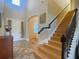 Entryway and staircase with view to front door and a wooden staircase at 9526 Lake Hugh Dr, Gotha, FL 34734