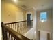 Hallway with decorative wrought iron spindles leading to the stairway at 9526 Lake Hugh Dr, Gotha, FL 34734