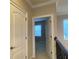 Hallway with an open doorway leading to a bedroom at 9526 Lake Hugh Dr, Gotha, FL 34734