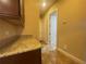 Hallway with tiled floors, granite countertops, and white doors at 9526 Lake Hugh Dr, Gotha, FL 34734