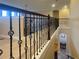 Hallway with decorative wrought iron spindles and hardwood floors at 9526 Lake Hugh Dr, Gotha, FL 34734