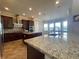 Large kitchen featuring granite countertops, stainless steel appliances, island, and custom cabinets at 9526 Lake Hugh Dr, Gotha, FL 34734