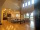 Open-concept living room with hardwood floors, comfortable seating, backyard view, and kitchen view at 9526 Lake Hugh Dr, Gotha, FL 34734