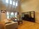 Bright living room with large windows, comfortable seating, wood floors, and stylish decor at 9526 Lake Hugh Dr, Gotha, FL 34734