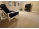 Relaxing living room featuring a large television and rocking chair at 9526 Lake Hugh Dr, Gotha, FL 34734