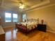 Spacious main bedroom with hardwood floors, tray ceiling, and a ceiling fan at 9526 Lake Hugh Dr, Gotha, FL 34734