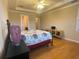 Serene main bedroom boasting hardwood floors and a TV for relaxing evenings at 9526 Lake Hugh Dr, Gotha, FL 34734