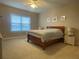 Spacious main bedroom with large window for ample natural light at 9526 Lake Hugh Dr, Gotha, FL 34734
