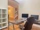 Home office setup with computer, desk, and view through an arched doorway at 9526 Lake Hugh Dr, Gotha, FL 34734