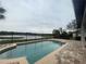 Breathtaking lake view from the refreshing pool area with brick paved deck, and a spacious patio at 9526 Lake Hugh Dr, Gotha, FL 34734