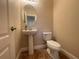 Small powder room featuring a pedestal sink and toilet at 9526 Lake Hugh Dr, Gotha, FL 34734