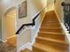 Wooden staircase features wooden steps and wrought iron spindles at 9526 Lake Hugh Dr, Gotha, FL 34734