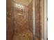 Walk-in shower with tiled walls, glass doors, and a shower head at 9526 Lake Hugh Dr, Gotha, FL 34734