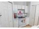 Kitchen area with white cabinets, a white electric stove and plentiful storage at 962 Nancy Ct, Kissimmee, FL 34759