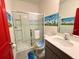 Themed bathroom with a glass enclosed shower, custom decor, and vibrant wall details at 10437 Ebb Tide Ln, Orlando, FL 32821