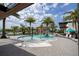 Resort-style pool area with splash pad, lounge chairs, and towering palm trees at 10437 Ebb Tide Ln, Orlando, FL 32821