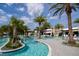 Lagoon style pool, palm trees, and lounge chairs create a relaxing and tropical vacation vibe at 10437 Ebb Tide Ln, Orlando, FL 32821