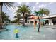 Community pool with splash zone, lounge chairs, umbrellas and views of the clubhouse at 10437 Ebb Tide Ln, Orlando, FL 32821