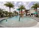 Zero entry pool features a splash zone, clubhouse views, and swaying palm trees at 10437 Ebb Tide Ln, Orlando, FL 32821