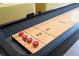 Close up of a shuffleboard table, showcasing its condition and readiness for friendly competition at 10437 Ebb Tide Ln, Orlando, FL 32821